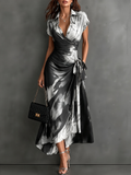 Vestido midi cruzado con estampado abstracto en blanco, cuello en V, manga corta, cintura para atar y bajo asimétrico con volantes