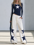 Claudia | Conjunto compuesto por un top de manga larga con estampado de estrellas azul marino y unos pantalones de pierna ancha